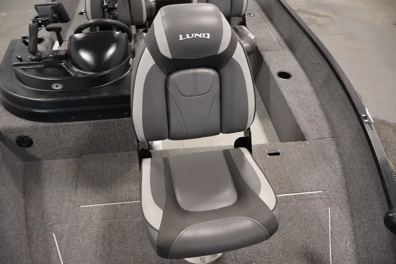 Slide: The Image of 2020 Lund 1650 Angler SS boat interior with gray seating and steering console. - 17