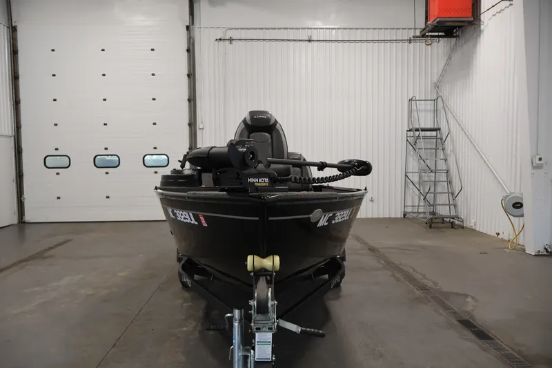 Slide: The Image of 2020 Lund 1650 Angler SS boat in a garage, front view with trailer attached. - 2