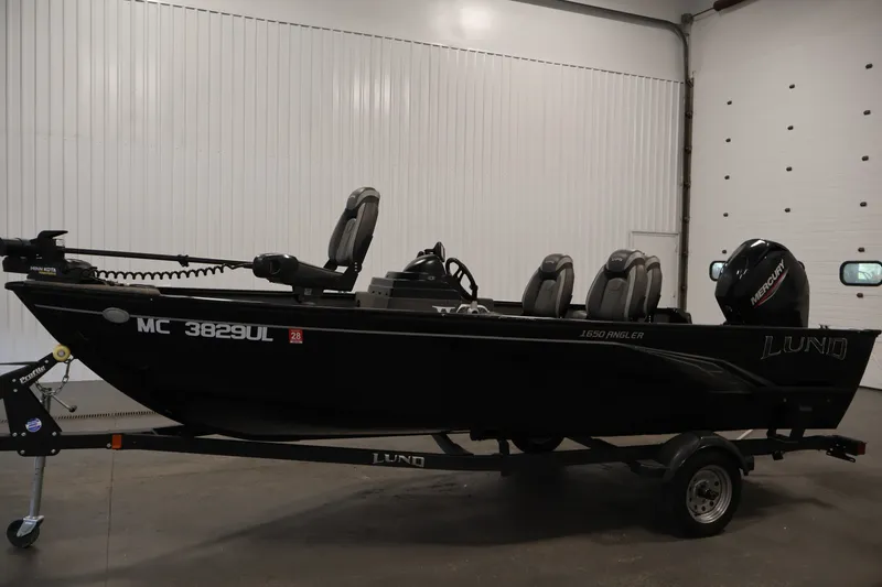 Slide: The Image of 2020 Lund 1650 Angler SS fishing boat on trailer in indoor setting. - 8