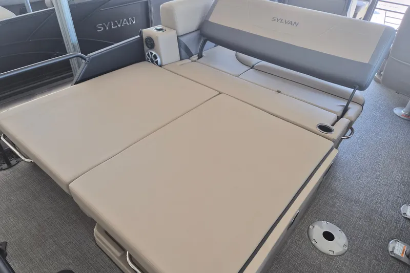 Slide: The Image of Luxurious Sylvan X3 DLZ DH BAR 2026 boat interior with beige seating and cup holders. - 17