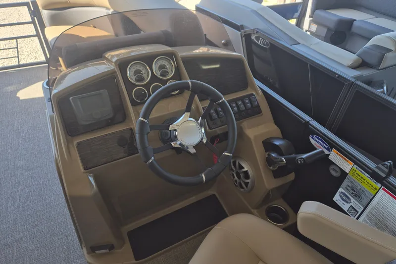 Slide: The Image of Steering console of 2026 Sylvan X3 DLZ DH BAR pontoon boat with modern controls. - 11