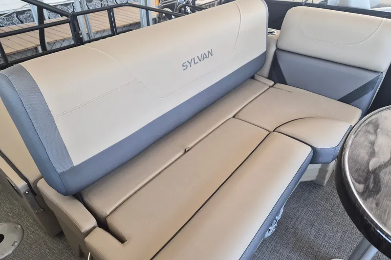 Slide: The Image of 2026 Sylvan X3 DLZ DH BAR boat interior with beige and gray seating. - 15