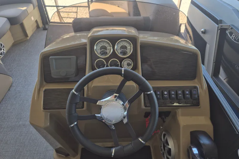 Slide: The Image of 2026 Sylvan X3 DLZ DH BAR boat dashboard with steering wheel and control panel. - 12