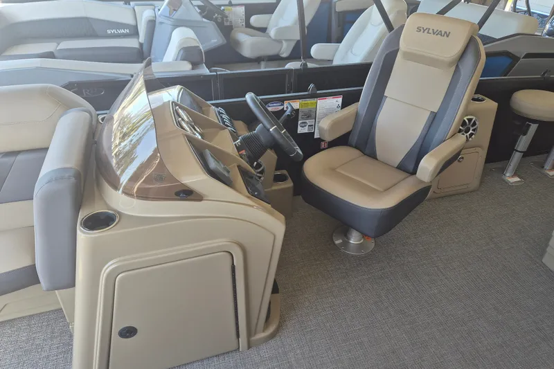 Slide: The Image of 2026 Sylvan X3 DLZ DH BAR boat interior with captain's chair and control console. - 6