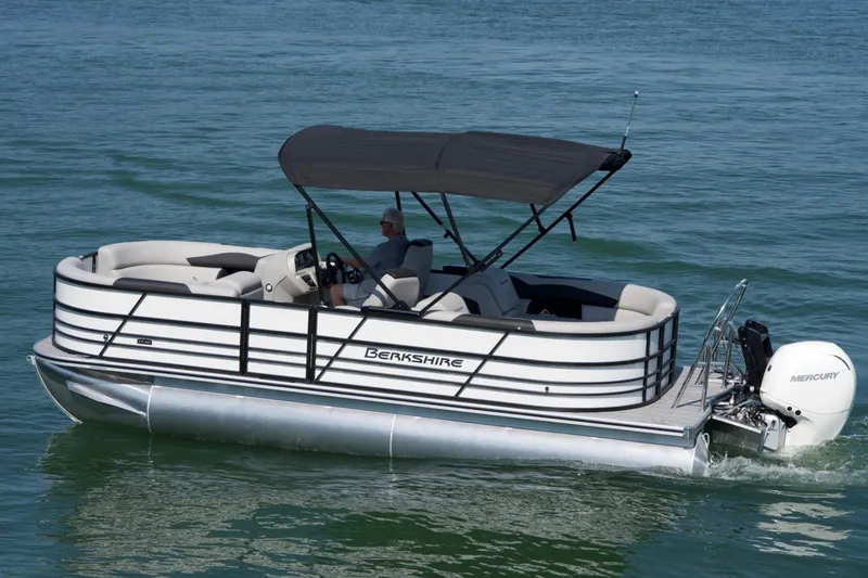 The Image of 2026 Berkshire 24RFX CTS pontoon boat cruising on water with canopy and Mercury engine. - 2