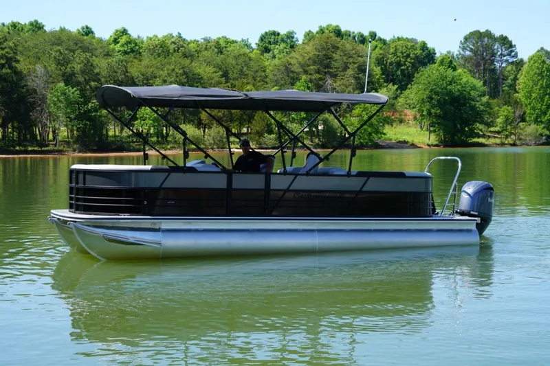 Slide: The Image of 2026 Berkshire 24RFX CTS pontoon boat on a serene lake with lush green surroundings. - 4
