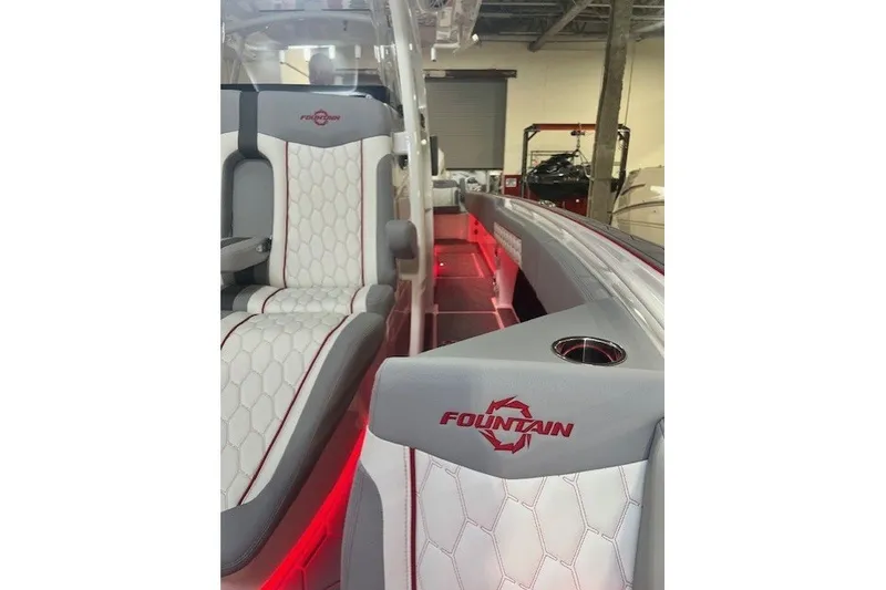 Slide: The Image of 2025 Fountain 34 SC boat interior with stylish seating and red accent lighting. - 19