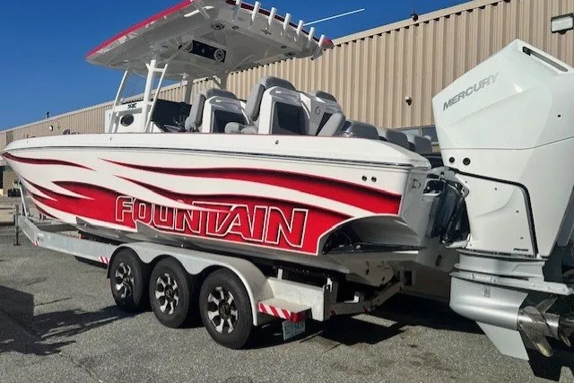 Slide: The Image of 2025 Fountain 34 SC boat with red graphics on a trailer, featuring Mercury engines. - 6