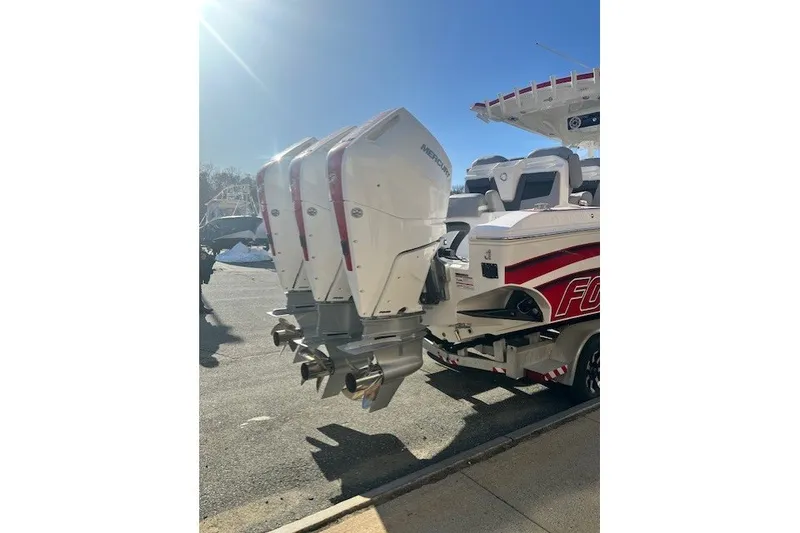 Slide: The Image of 2025 Fountain 34 SC boat with triple outboard engines in sunlight. - 9