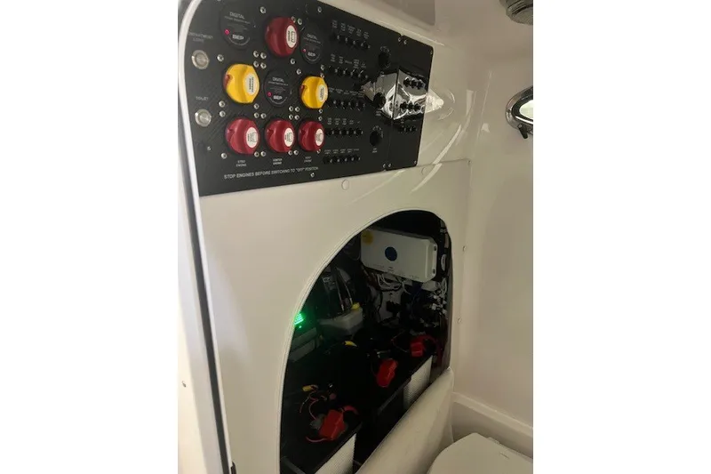 Slide: The Image of Control panel and wiring inside a 2025 Fountain 34 SC boat. - 24