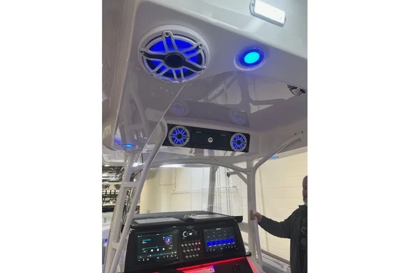 Slide: The Image of 2025 Fountain 34 SC boat interior with blue LED lights and audio system. - 26