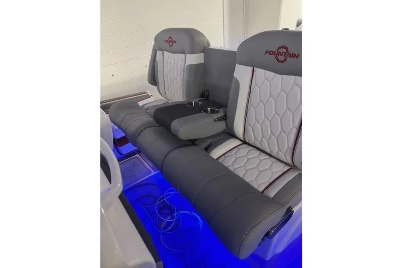 Slide: The Image of 2025 Fountain 34 SC boat seats with blue LED lighting and cup holders. - 29