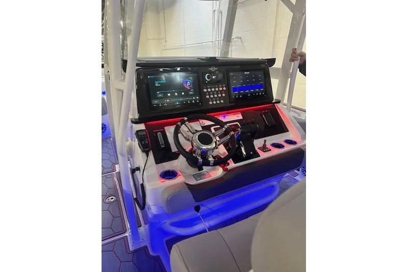 Slide: The Image of 2025 Fountain 34 SC boat dashboard with illuminated controls and advanced navigation displays. - 25