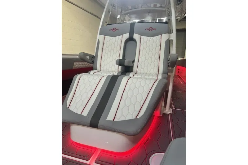 Slide: The Image of Luxurious seating in 2025 Fountain 34 SC boat with red ambient lighting. - 28