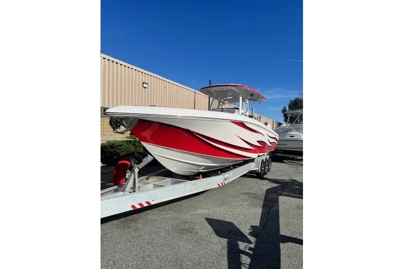 Slide: The Image of 2025 Fountain 34 SC boat with red and white design on a trailer. - 8