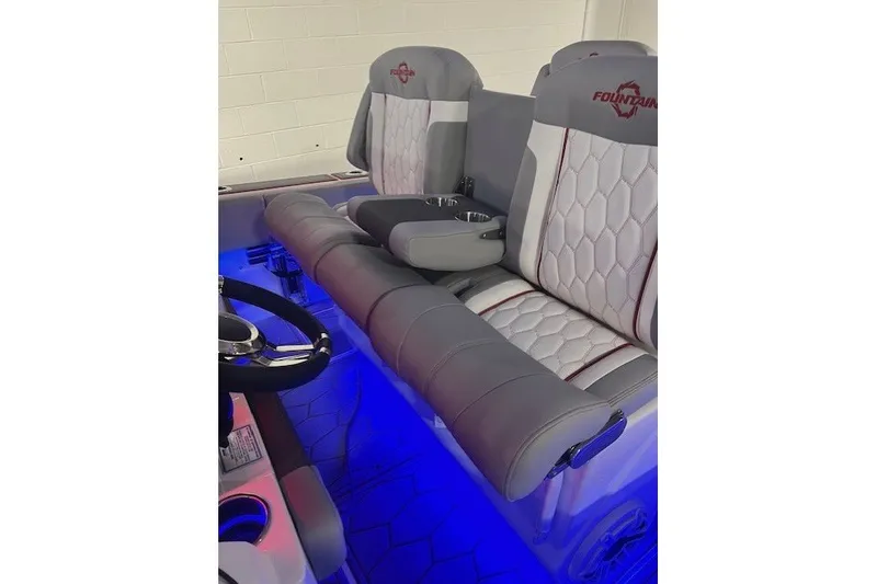 Slide: The Image of 2025 Fountain 34 SC boat interior with illuminated seating and steering wheel. - 23