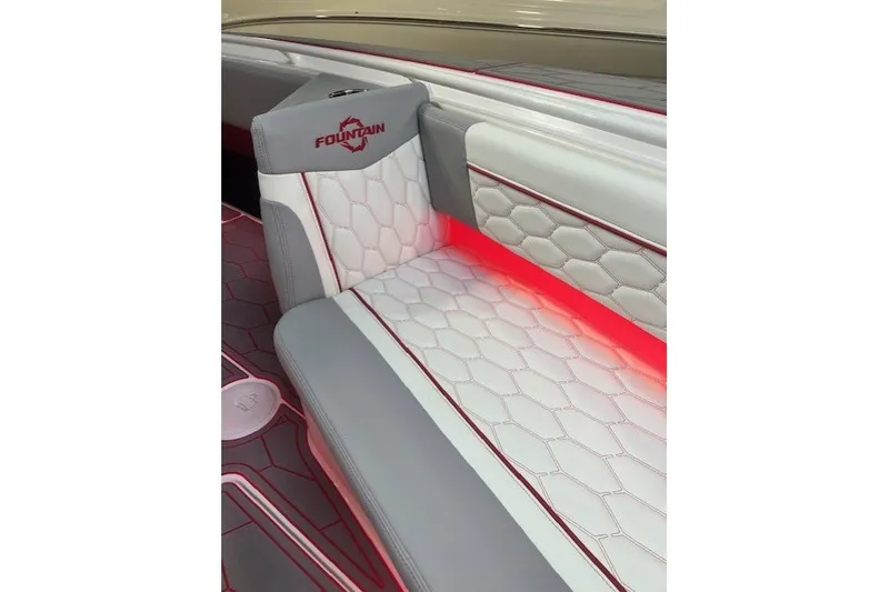 Slide: The Image of Luxurious seating in 2025 Fountain 34 SC boat with red accent lighting. - 27