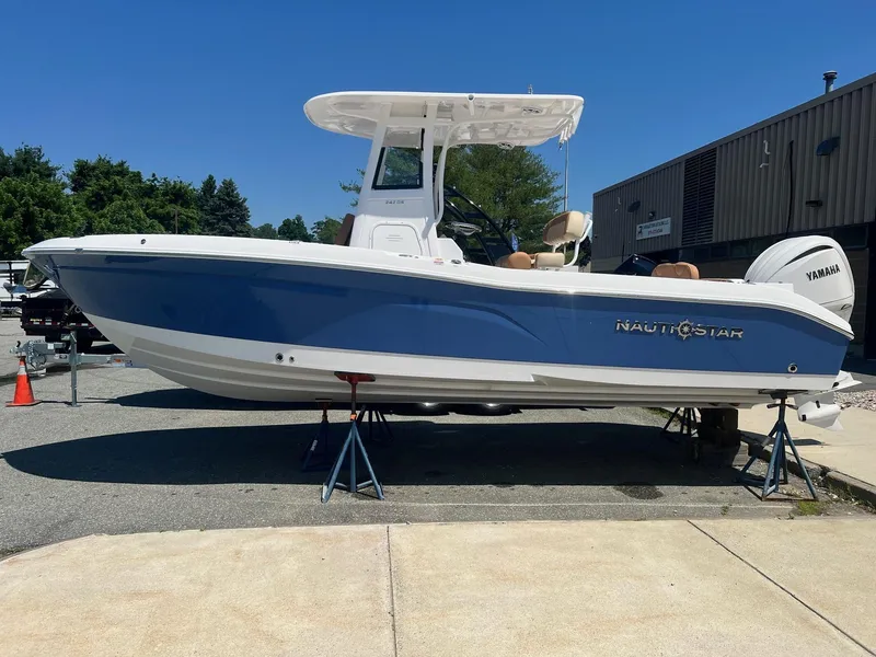 The Image of 2025 NauticStar 242 Offshore boat on stands outside. - 0