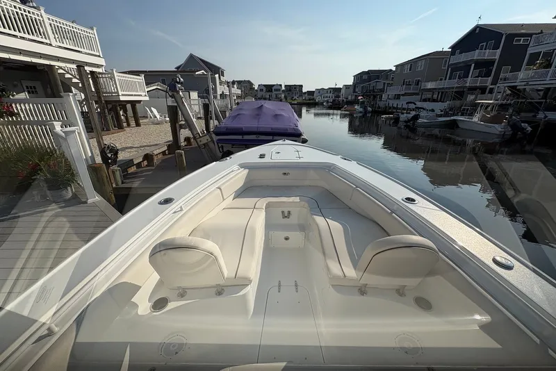 Slide: The Image of 2022 Sea Hunt Ultra 275SE boat docked in a residential canal setting. - 10