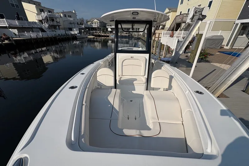 Slide: The Image of 2022 Sea Hunt Ultra 275SE boat docked in a residential canal setting. - 12