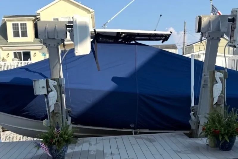 Slide: The Image of Covered 2022 Sea Hunt Ultra 275SE boat on a dock with decorative posts. - 15
