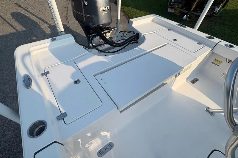 Slide: The Image of 2019 Sportsman Masters 227 Bay Boat deck with Yamaha 150 engine, showcasing storage compartments. - 10