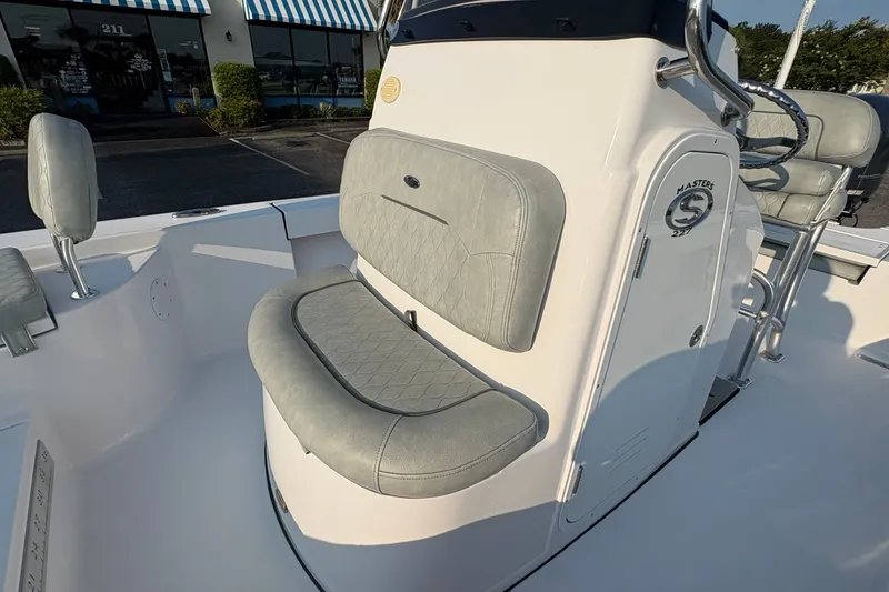 Slide: The Image of 2019 Sportsman Masters 227 Bay Boat interior with cushioned seating and console. - 20