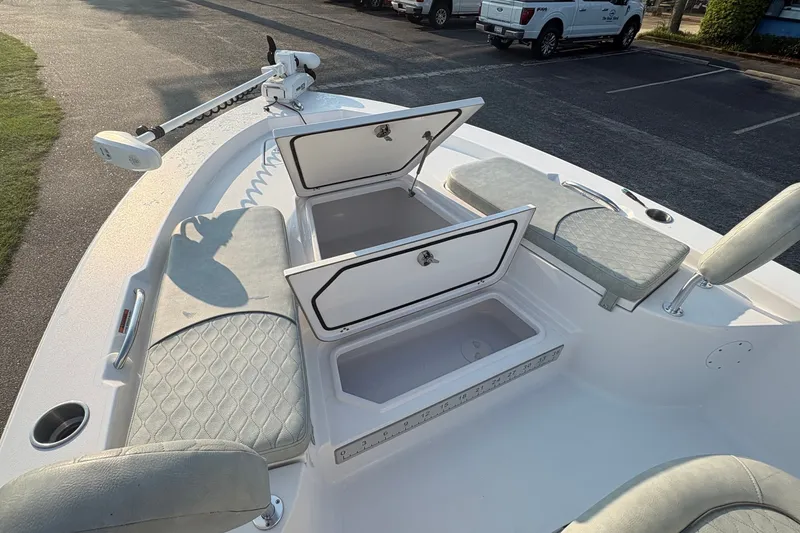 Slide: The Image of 2019 Sportsman Masters 227 Bay Boat with open storage compartments and cushioned seating. - 22