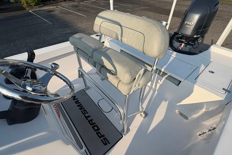 Slide: The Image of 2019 Sportsman Masters 227 Bay Boat interior with steering wheel and seating. - 13