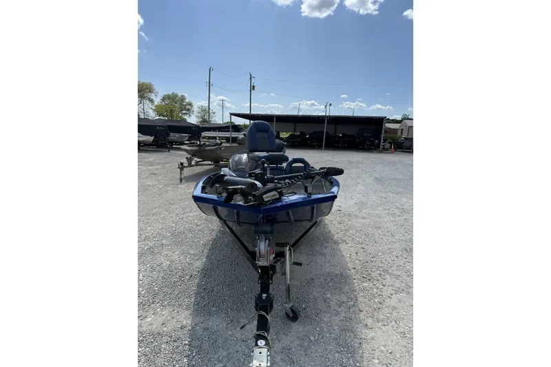 Slide: The Image of 2014 Lowe Stinger 175 boat on trailer in outdoor lot under blue sky. - 2