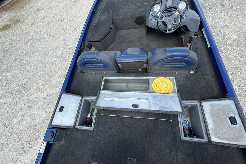 Slide: The Image of 2014 Lowe Stinger 175 boat interior with storage compartments and steering console. - 10