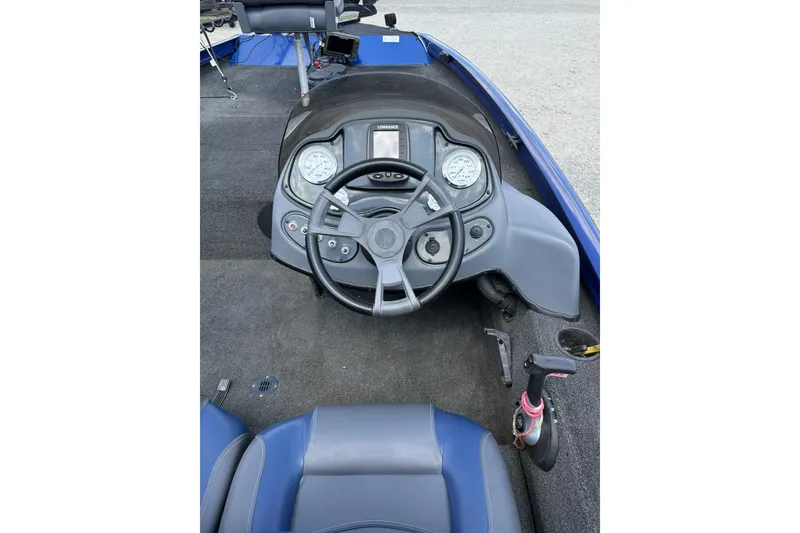 Slide: The Image of 2014 Lowe Stinger 175 boat cockpit with steering wheel and control panel. - 5