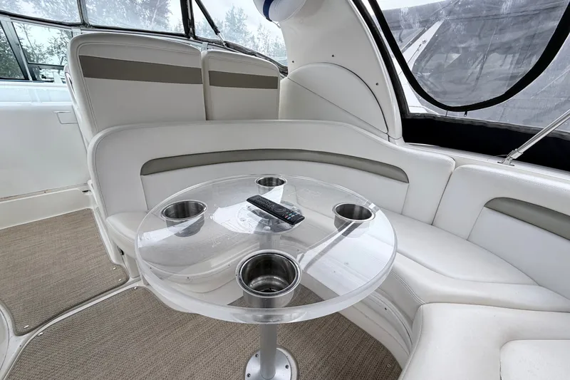 Slide: The Image of Interior of 2006 Sea Ray Sundancer 320 with plush seating and a transparent table. - 6