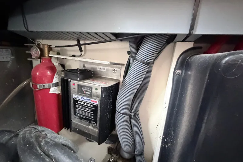 Slide: The Image of Engine compartment of a 2006 Sea Ray Sundancer 320 with fire extinguisher and electrical components. - 39