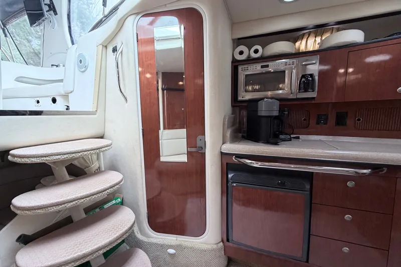 Slide: The Image of Interior of 2006 Sea Ray Sundancer 320 yacht with kitchenette and stairs. - 27