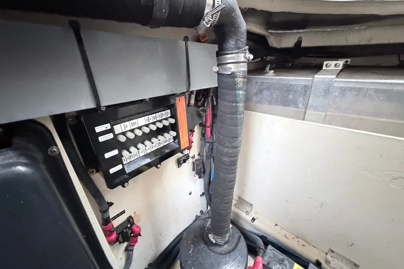 Slide: The Image of Engine compartment of a 2006 Sea Ray Sundancer 320, showing electrical panel and hoses. - 41