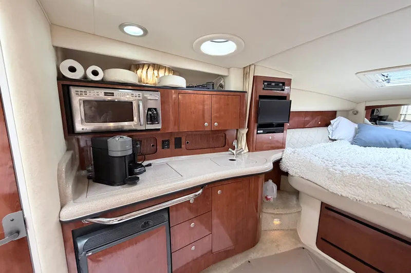 Slide: The Image of Interior of 2006 Sea Ray Sundancer 320 yacht with kitchenette and cozy sleeping area. - 19