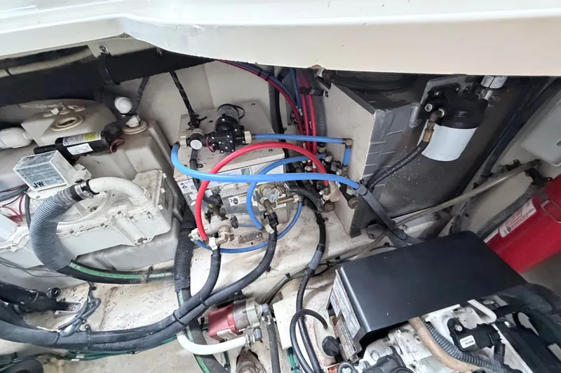 Slide: The Image of Engine compartment of a 2006 Sea Ray Sundancer 320 with visible wiring and components. - 38