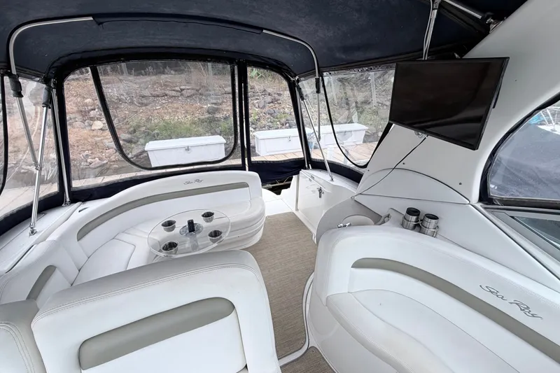 Slide: The Image of Interior of a 2006 Sea Ray Sundancer 320 boat with seating and a mounted TV. - 12