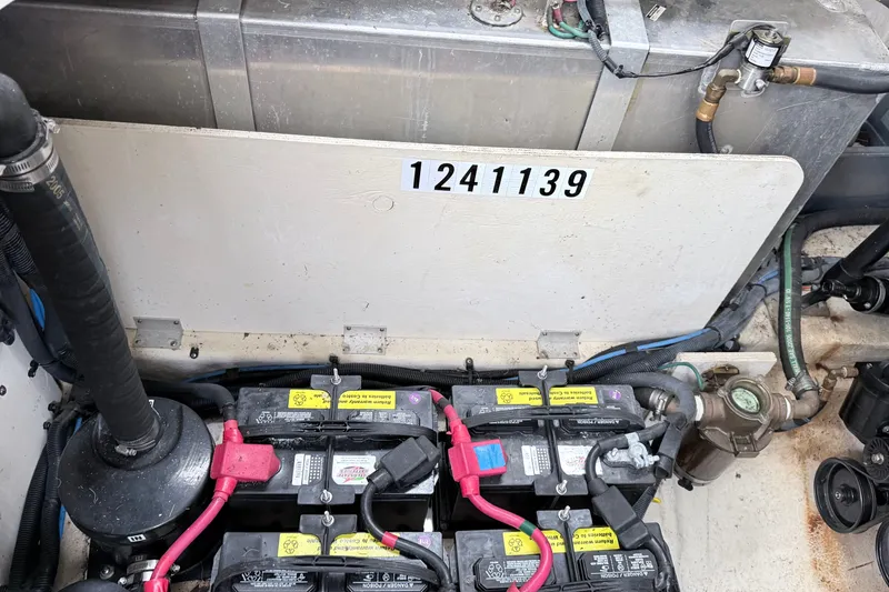Slide: The Image of Engine compartment of a 2006 Sea Ray Sundancer 320 with visible batteries and wiring. - 37