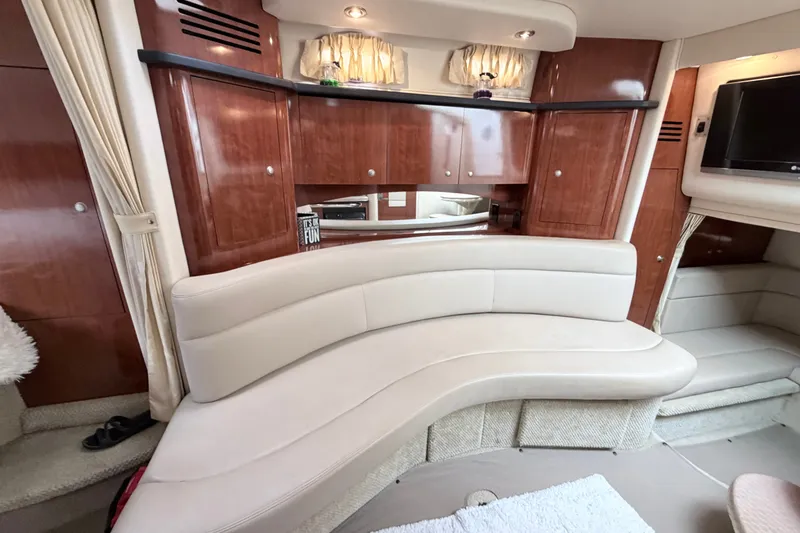 Slide: The Image of Luxurious interior of 2006 Sea Ray Sundancer 320 with elegant wood cabinetry and curved seating. - 22