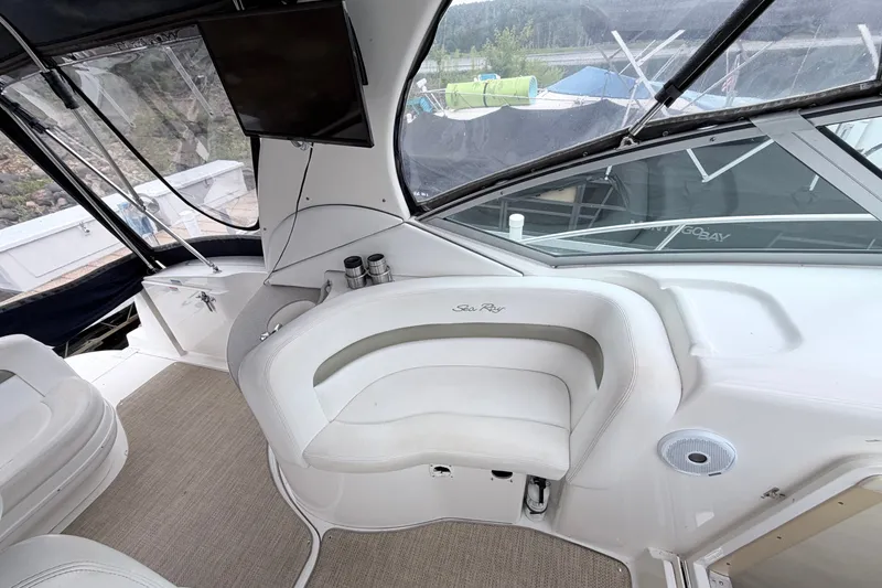 Slide: The Image of Interior of a 2006 Sea Ray Sundancer 320 yacht with white seating and a mounted TV. - 13