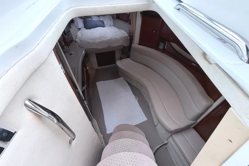 Slide: The Image of Interior of 2006 Sea Ray Sundancer 320, featuring cozy seating and sleeping area. - 17