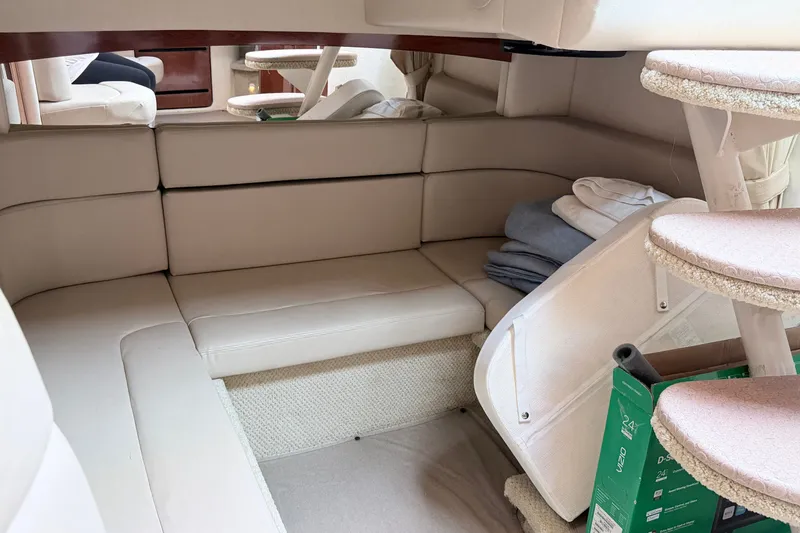 Slide: The Image of Interior of 2006 Sea Ray Sundancer 320, featuring beige seating and compact design. - 26