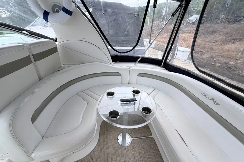 Slide: The Image of Luxurious 2006 Sea Ray Sundancer 320 interior with curved seating and a glass table. - 16