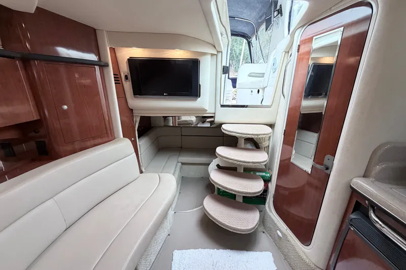 Slide: The Image of Interior of 2006 Sea Ray Sundancer 320 yacht with seating, TV, and stairs. - 24