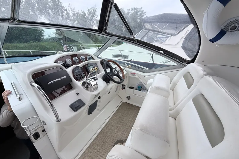 Slide: The Image of Interior cockpit of 2006 Sea Ray Sundancer 320 with steering wheel and navigation equipment. - 9