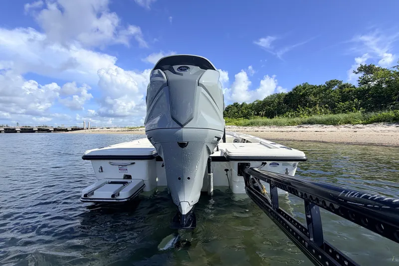 Slide: The Image of 2015 Pathfinder 2200 Tournament Edition boat docked near sandy shore under blue sky. - 23