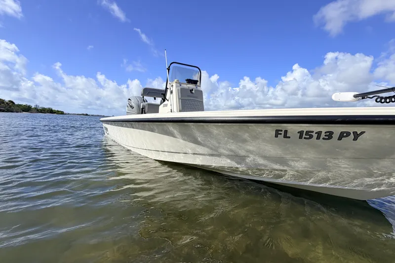 Slide: The Image of 2015 Pathfinder 2200 Tournament Edition boat on calm water under a clear blue sky. - 15