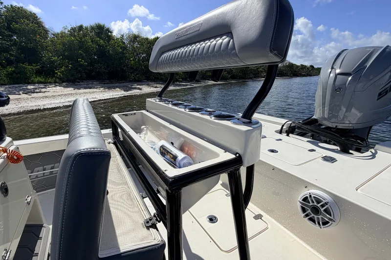 Slide: The Image of 2015 Pathfinder 2200 Tournament Edition boat interior with seating and storage, near shoreline. - 32